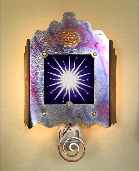 The nightlight is shown here with the light off.  A white spikey star with a black background.