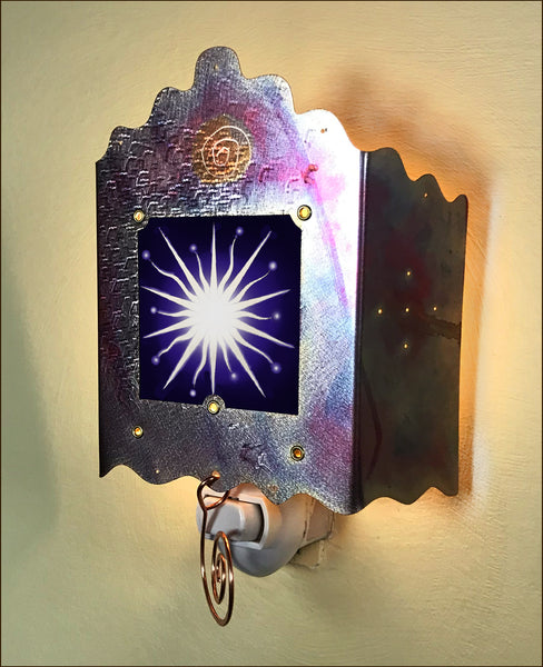 The nightlight is shown here with the light off.  A white spikey star with a black background.